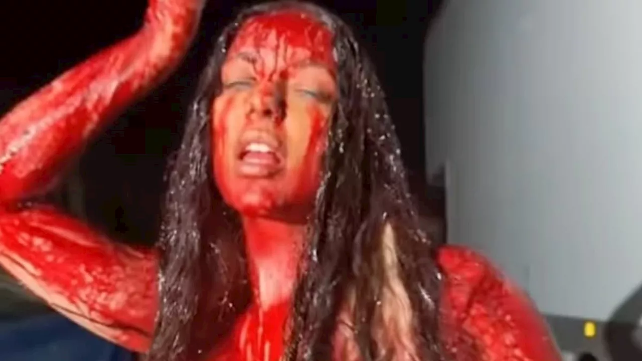 Singer looks unrecognisable in blood-spattered Carrie costume as she promotes her new single with...