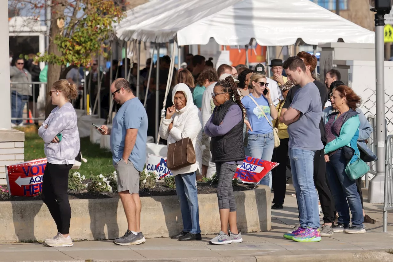 Cuyahoga County early voters stick it out in line to cast their ballots as they ‘get it all over with’