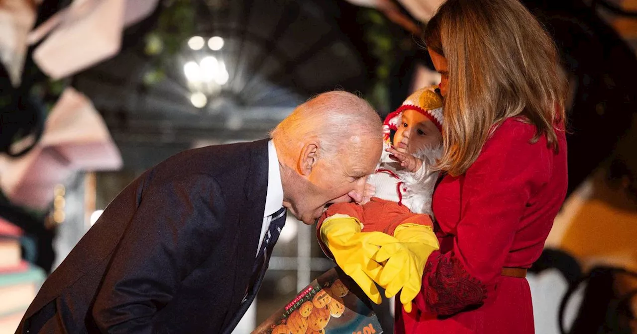 Joe Biden puts baby's foot in his mouth after kids come dressed for Halloween