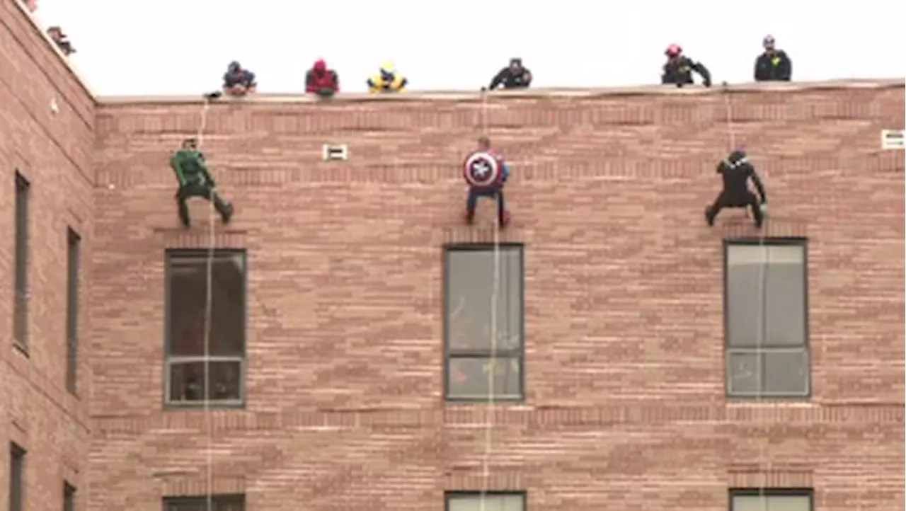 Halloween Tradition: Superheroes repel down hospital to visit children