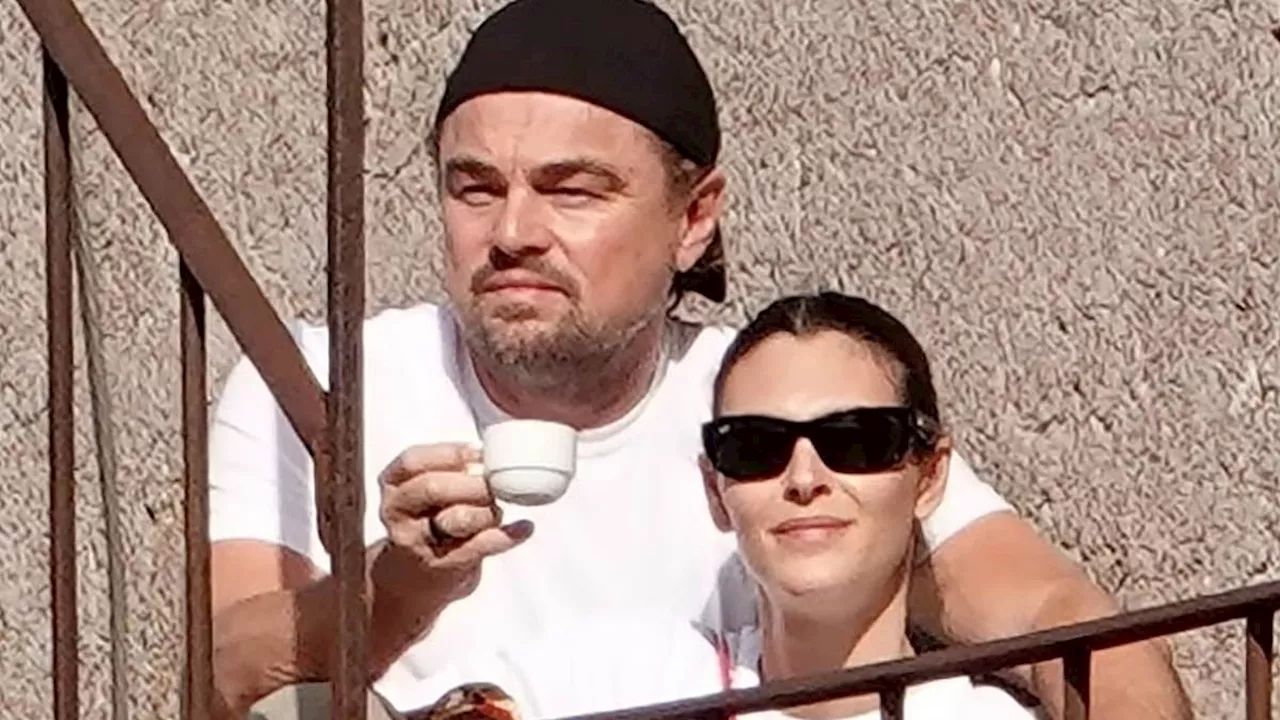 Leonardo DiCaprio, 49, cuddles up to girlfriend Vittoria Ceretti, 26, in Rome where they are joined...