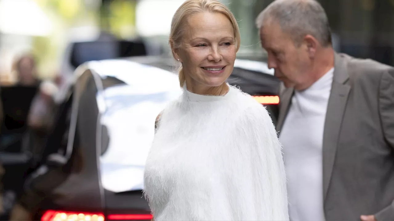 Pamela Anderson Wore the Pantsuit Version of Her Iconic Fuzzy Hat