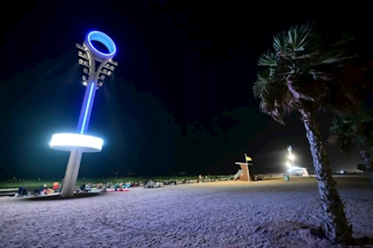 Too hot by day, Dubai's floodlit beaches are packed at night