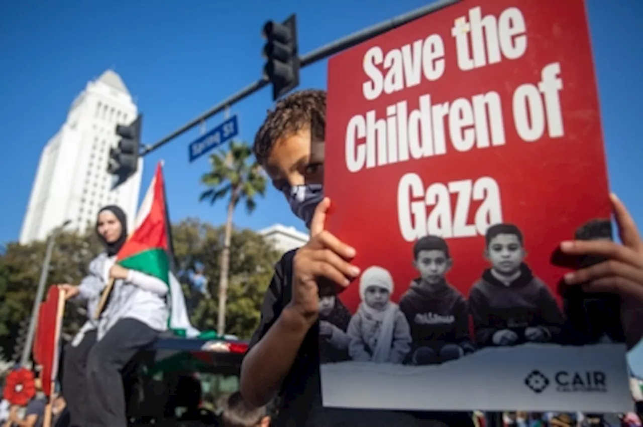 ‘Tired of our tax money going to Israel to bomb kids’: Man sets arm on fire as thousands march across US marking Gaza war anniversary, calling for ceasefire