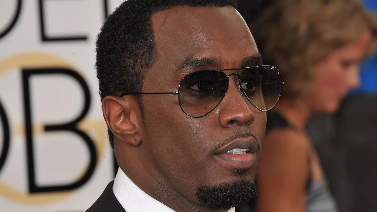 Diddy goes in to kiss Bono but singer rejects him during VERY awkward encounter on stage in...