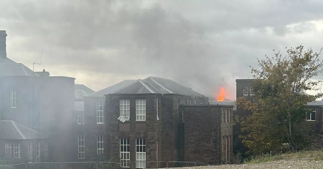 Fire crews battle blaze at old Scots hospital as flames burst through building