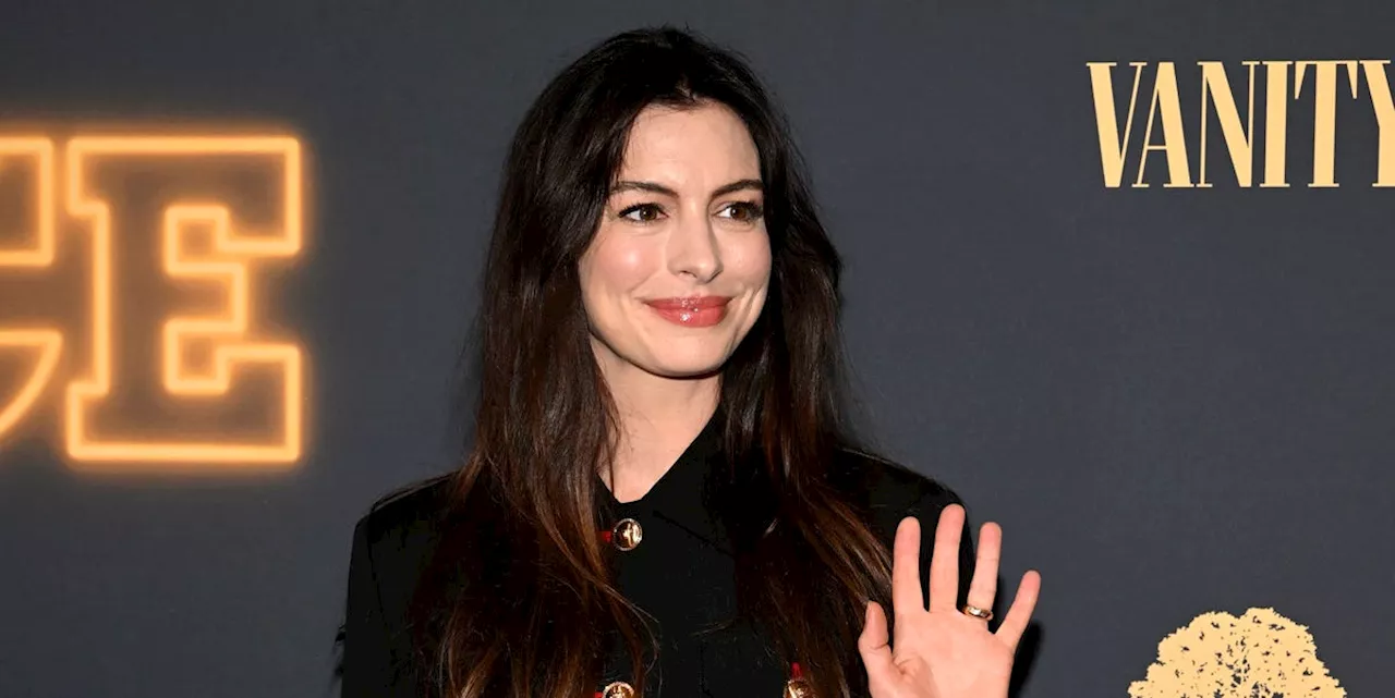 Anne Hathaway puts a glamorous twist on the long black coat in New York