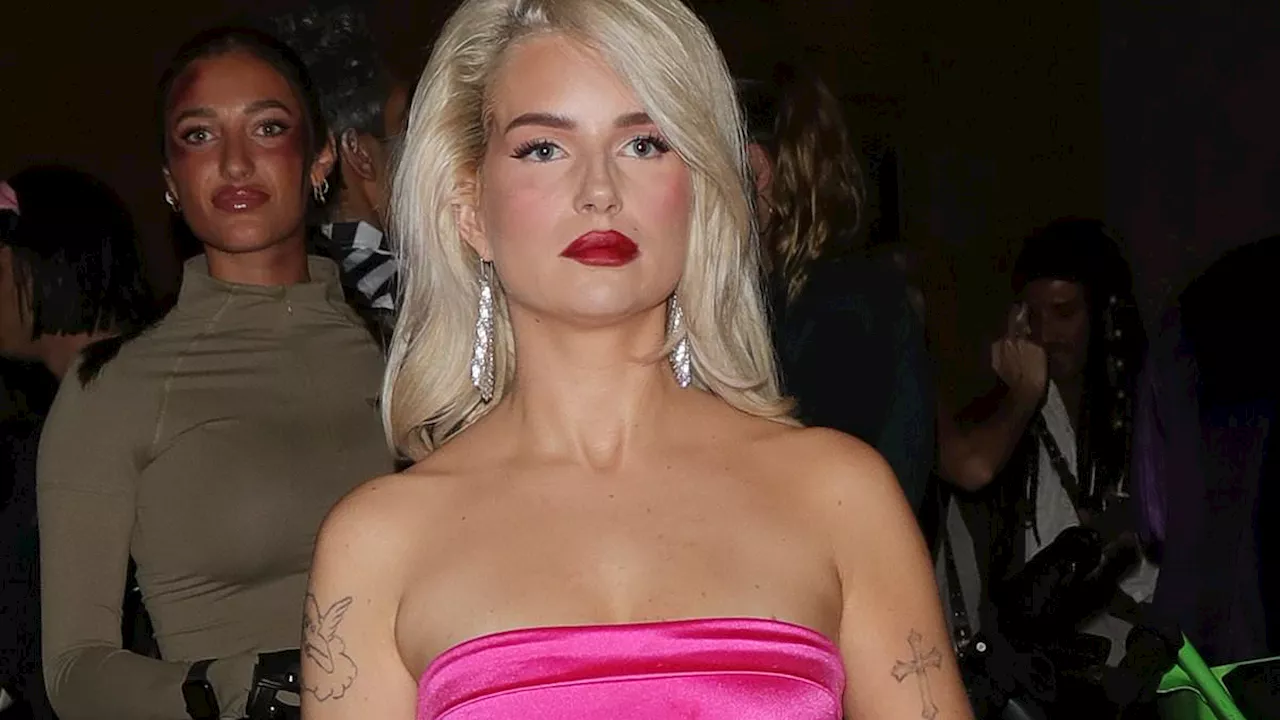 Lottie Moss puts on a leggy display in a Marilyn Monroe-inspired hot pink mini dress and knee high...