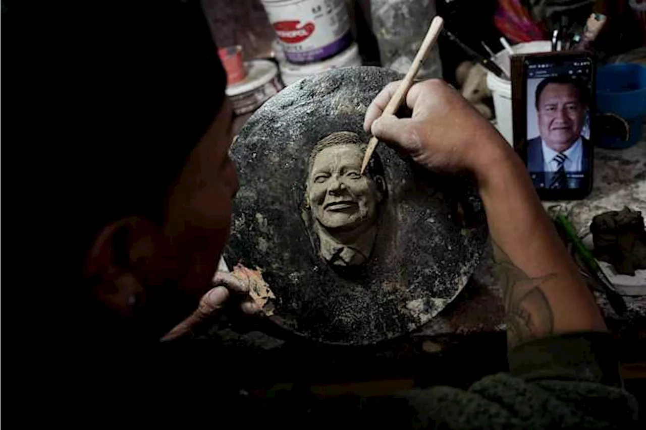 A Bolivian artist carves faces of the departed onto Day of the Dead bread