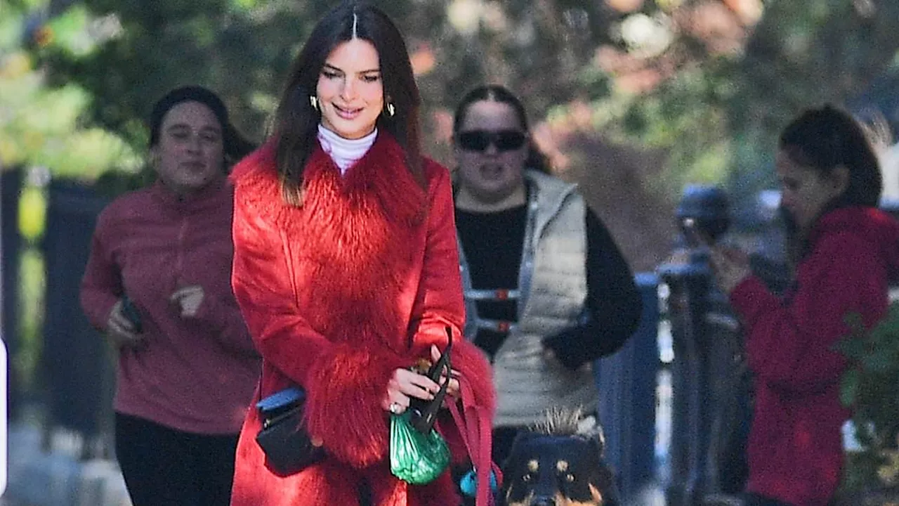 Emily Ratajkowski flashes leg in glam red coat as she walks her dog in New York City