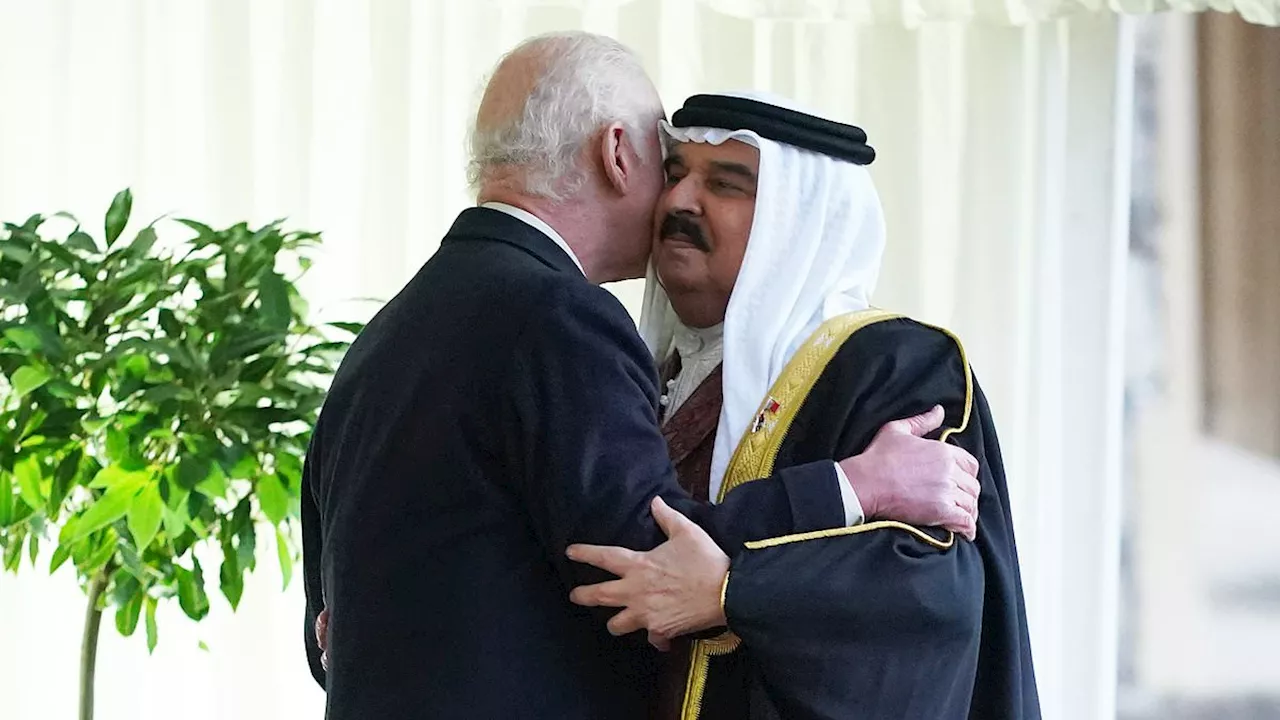 Charles grins as he welcomes King of Bahrain to Windsor Castle with a warm hug