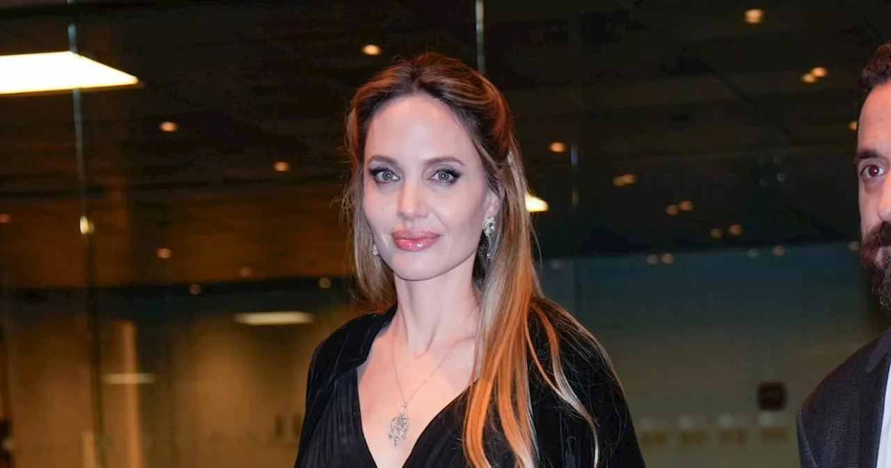 Angelina Jolie Nails Opera Glamour in Plunging Black Gown & Dramatic Shawl