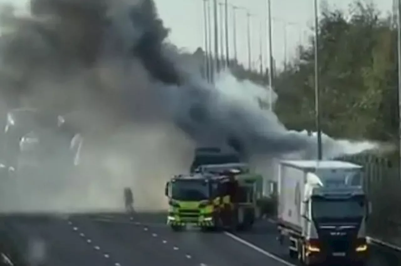 Moment huge lorry blaze sends plumes of black smoke billowing over motorway sparking traffic chaos for...