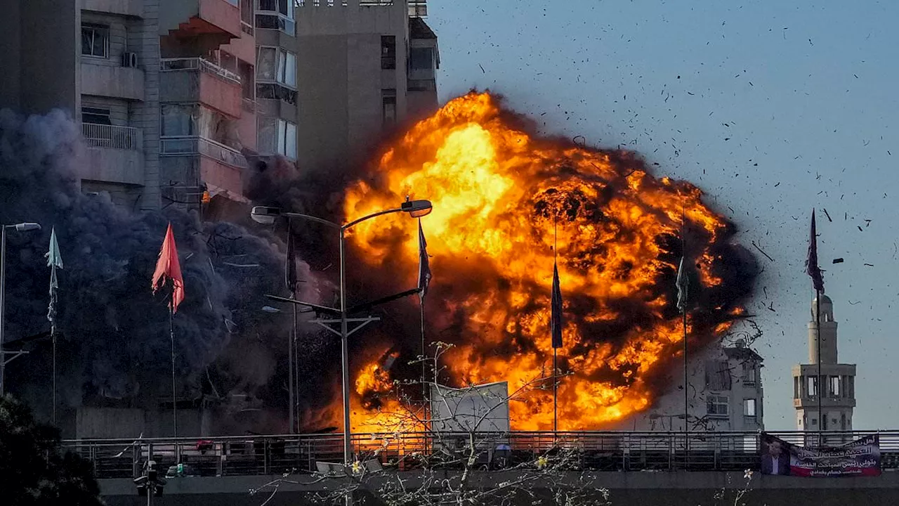 Astonishing moment Israeli rocket slams into Beirut tower block before it collapses in huge fireball...