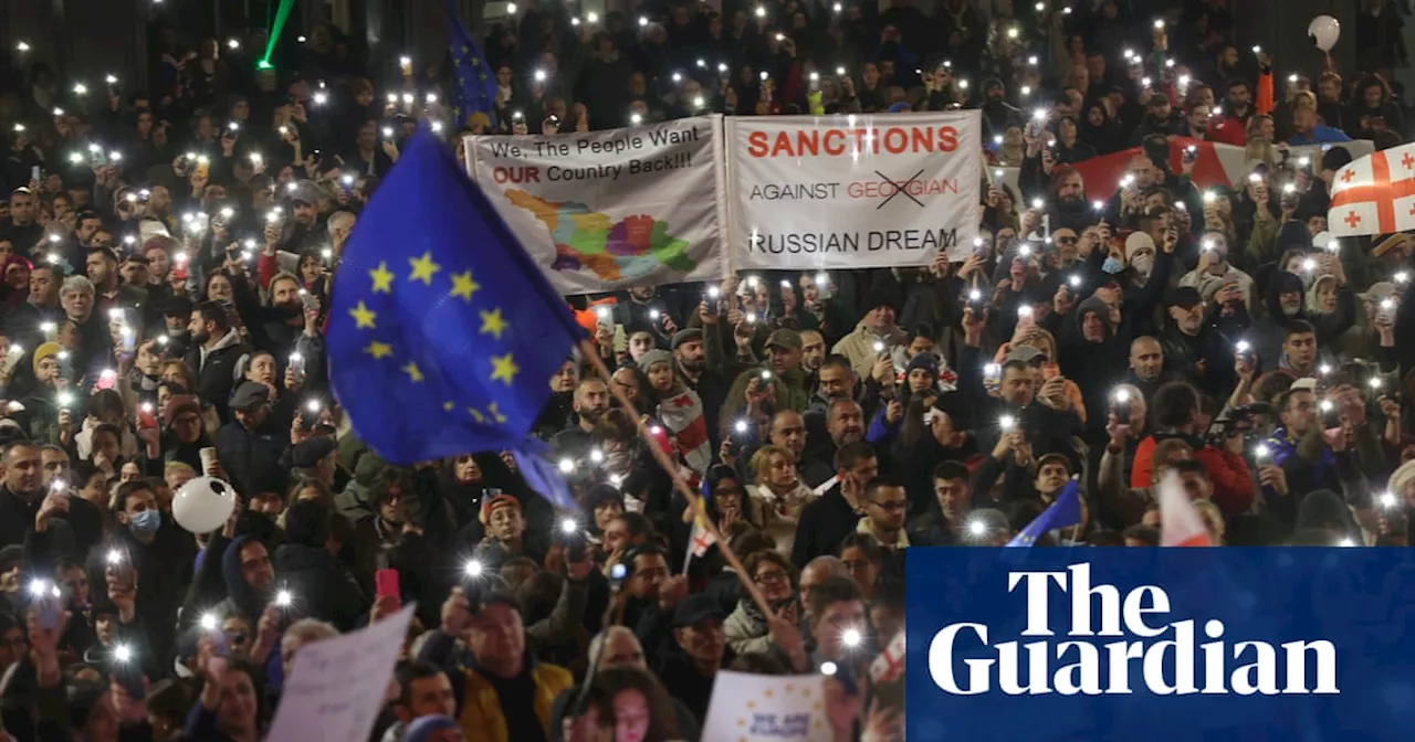 Protests in Georgia over disputed vote as PM threatens to ban opposition