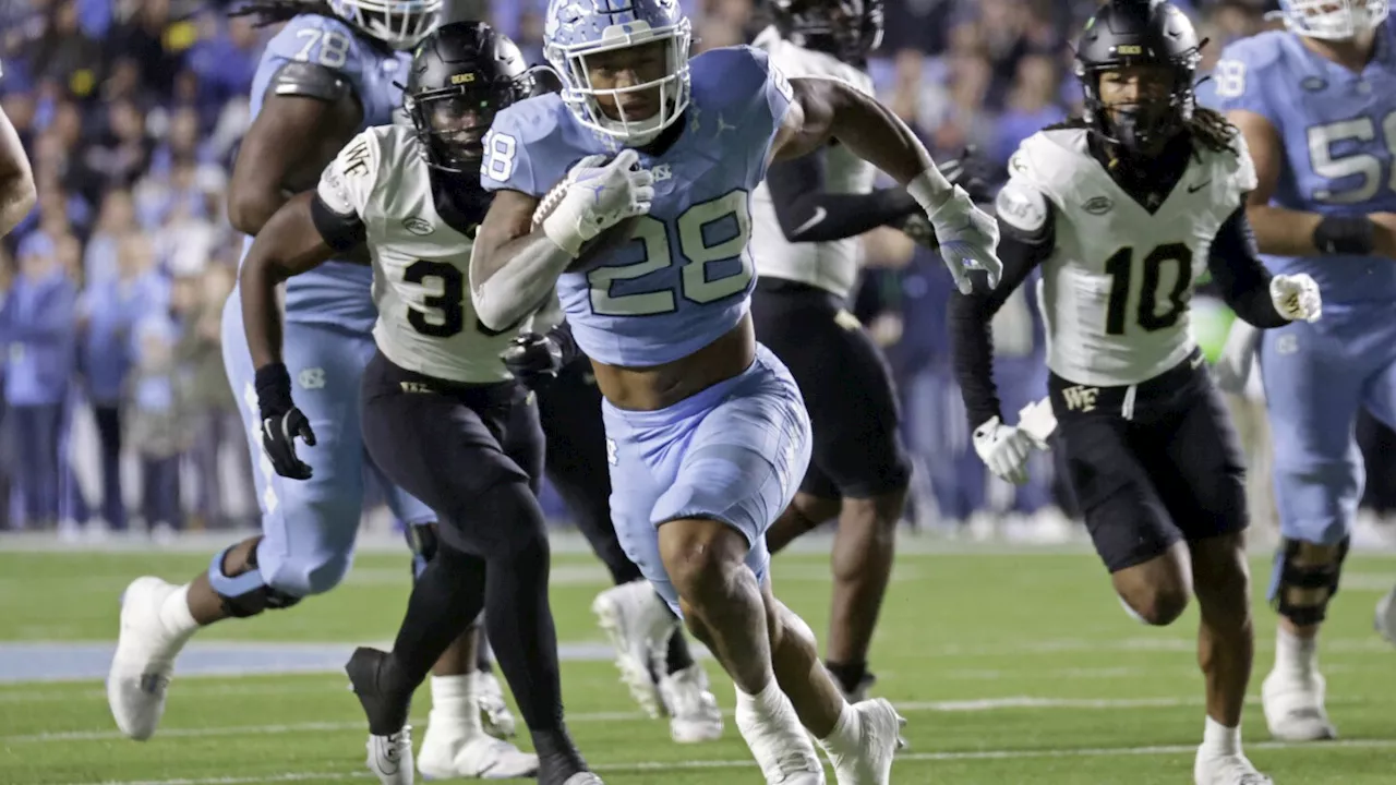 Hampton's huge day helps North Carolina hold off Wake Forest 31-24 to reach bowl eligibility