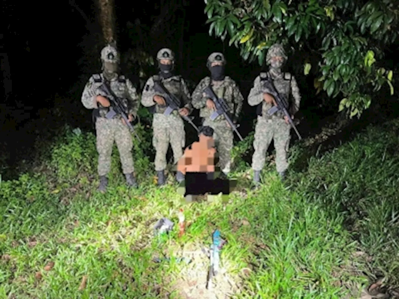 Malaysian infantry patrol busts Thai poacher carrying home-made rifle, axe, ketum