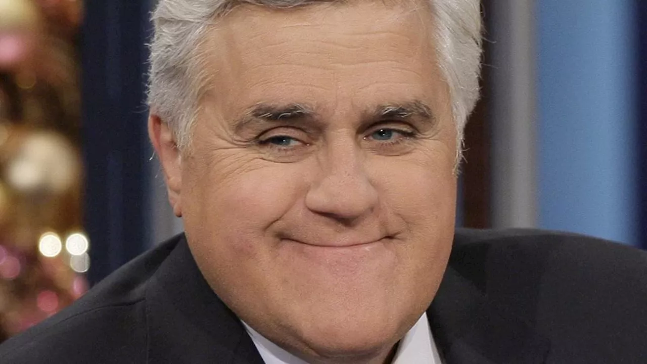 Bruised Jay Leno pictured behind the wheel after horrific 60ft fall left him with eyepatch and...