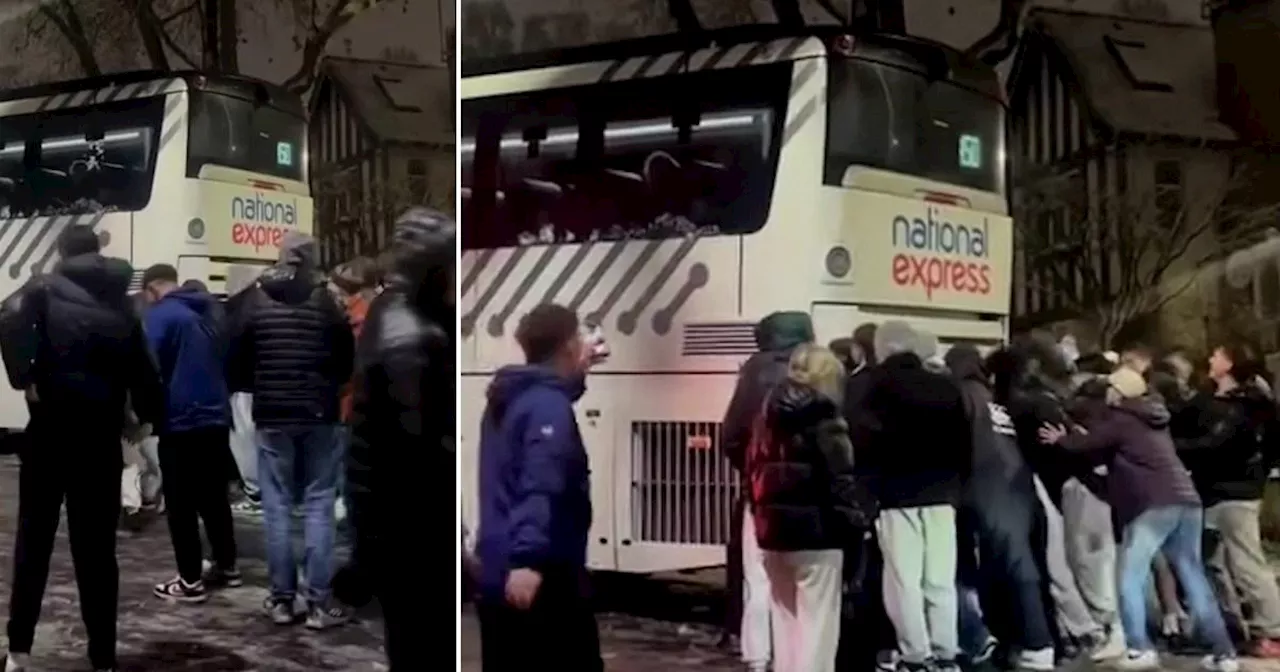 National Express coach is saved from slipping down hill on icy road by passengers