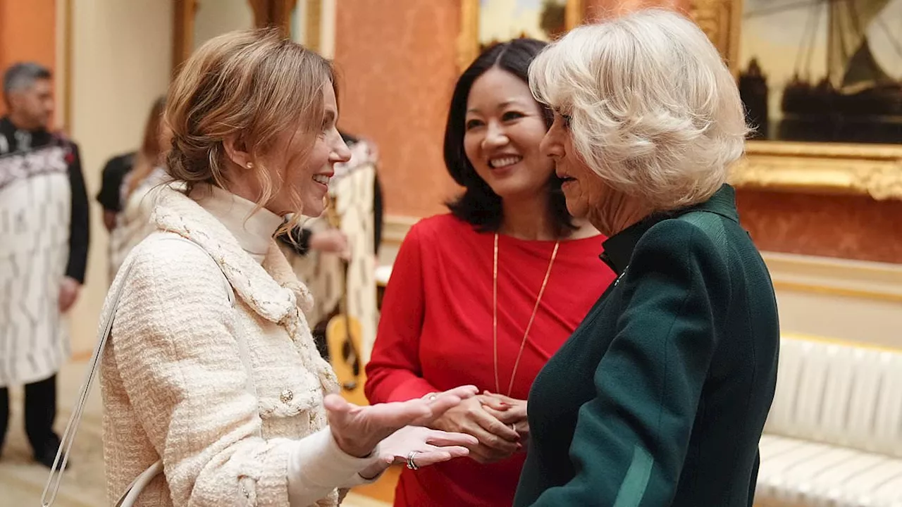 Queen Camilla chats to Geri Horner at Buckingham Palace reception for winners of the Commonwealth...