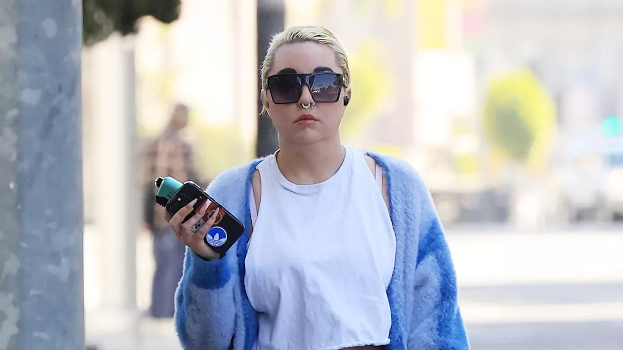 Amanda Bynes flashes her taut midriff in a white crop top while out vaping in LA