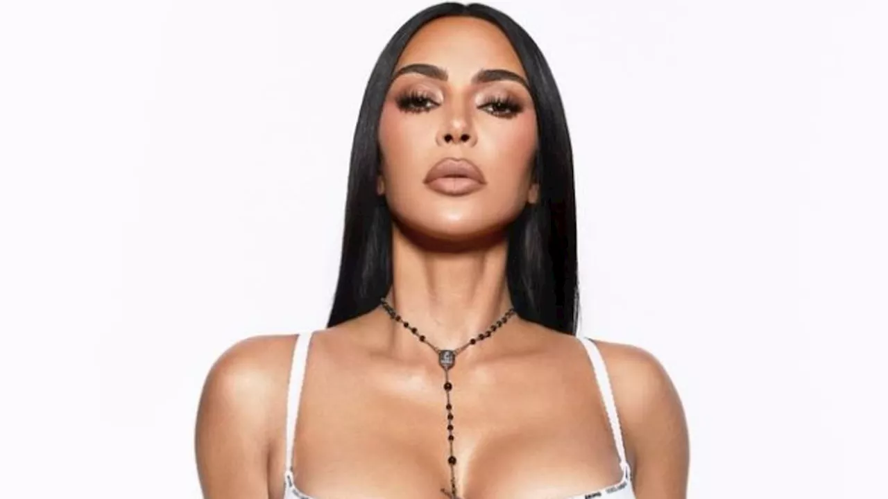 Kim Kardashian fans outraged as she wears a rosary while pulling down her underwear for new Skims...