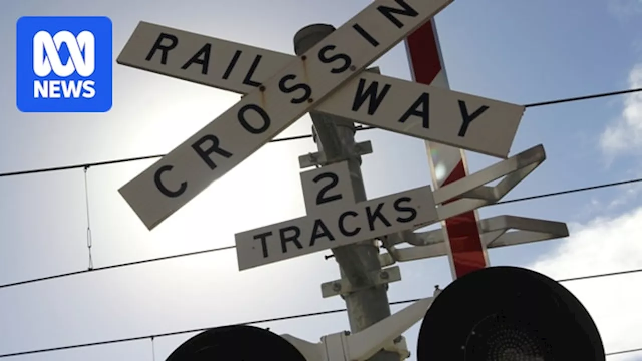 Two men fighting for life after car collides with freight train in far north Queensland