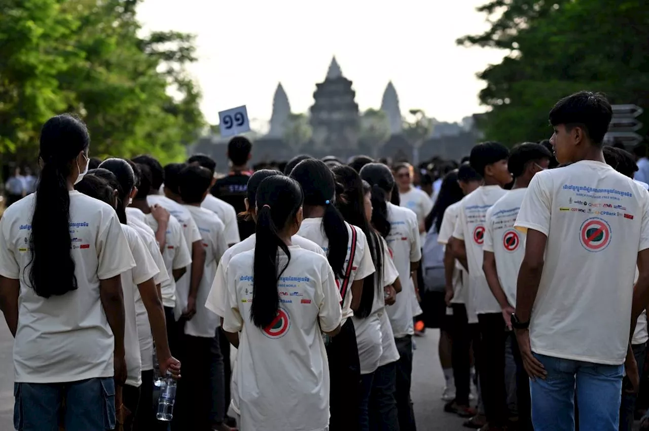 Survivors, dogs join Cambodia anti-mine march