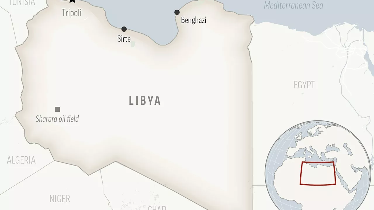 Armed men in speedboats make off with women and children when a migrants' dinghy deflates off Libya