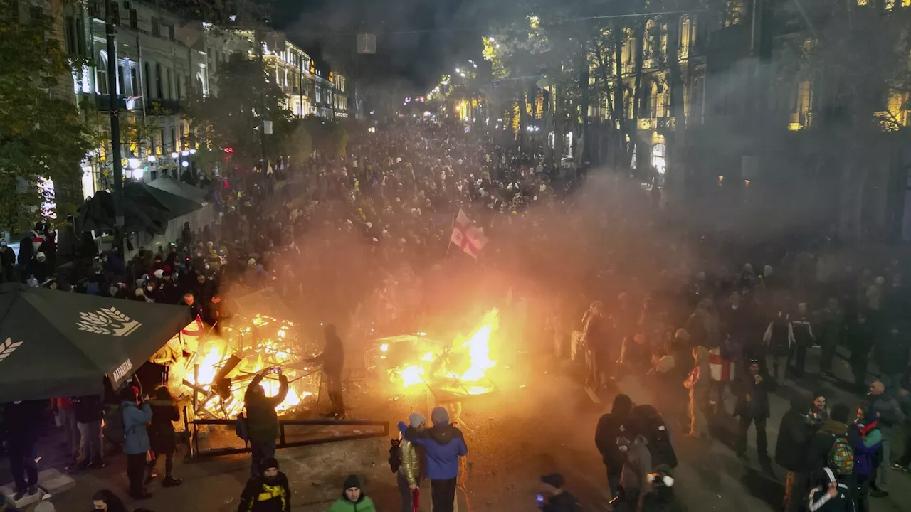 Georgian protesters and police clash after prime minister suspends talks on joining the EU