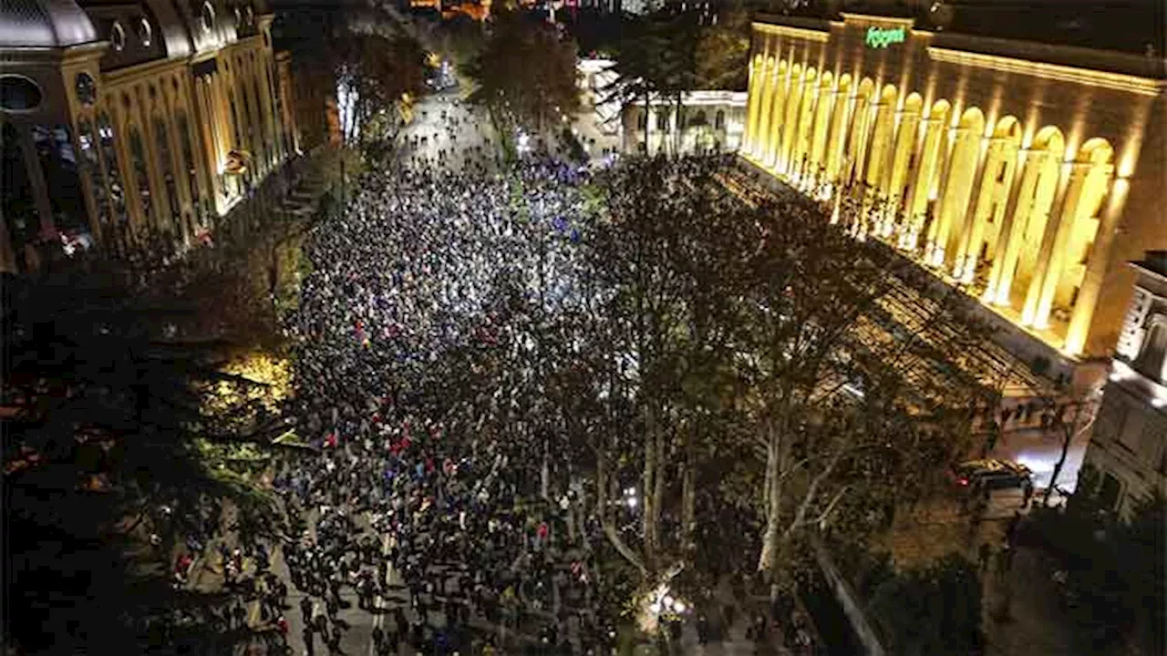 Georgian protesters and police clash after prime minister suspends talks on joining the EU