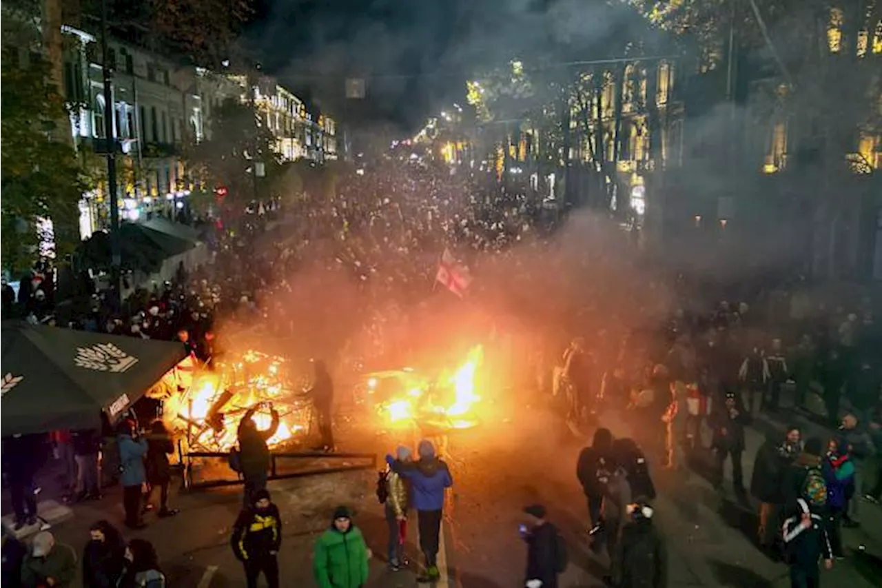 Georgian protesters and police clash after prime minister suspends talks on joining the EU