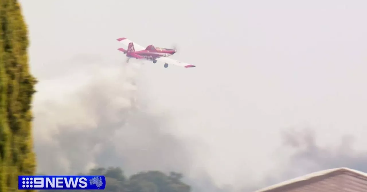 Two charged after bushfire almost engulfs neighbour's property