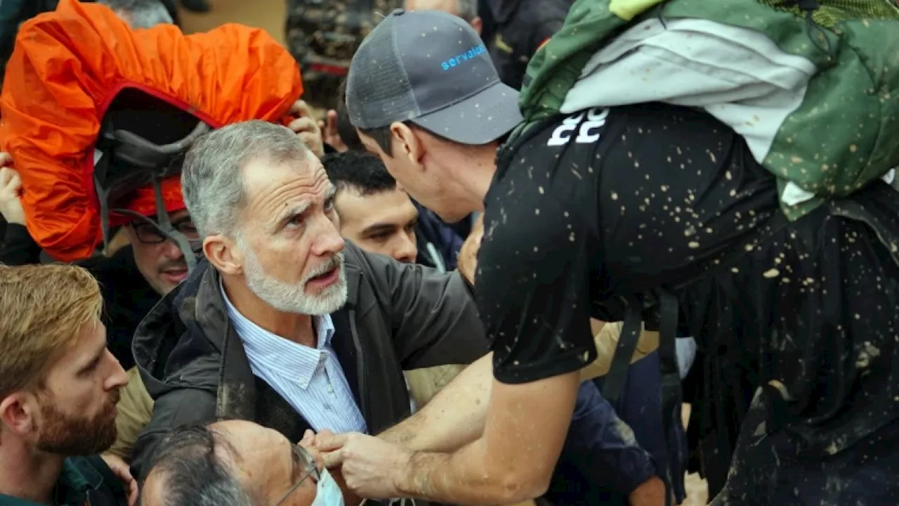 Angry crowds throw mud and shout insults at Spanish king as he tours flood damage