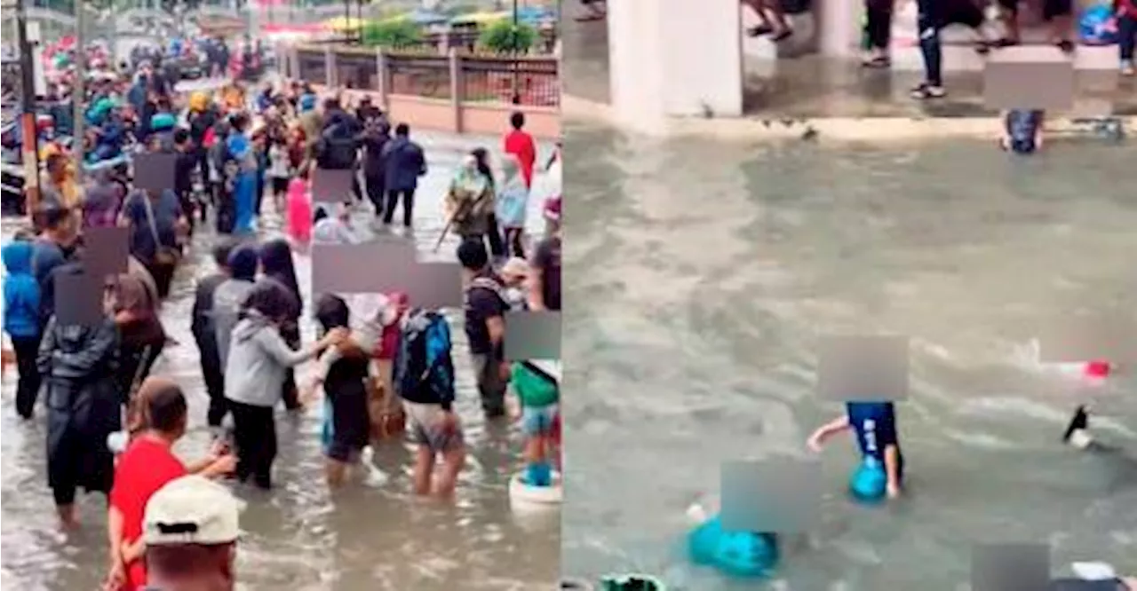 Kelantan folks play in floodwaters, dubbing it “Kota Bharu waterpark”