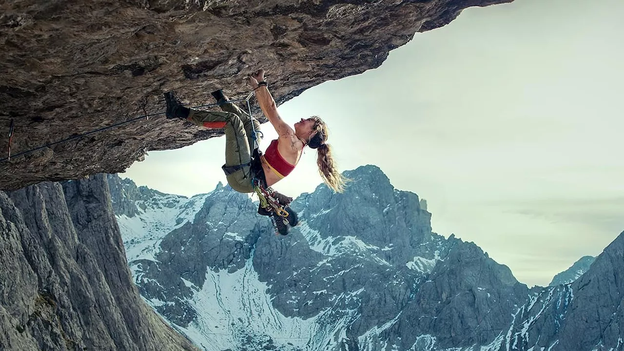 Lily James fearlessly scales a mountain as she takes over Sylvester Stallone's Cliffhanger role in...