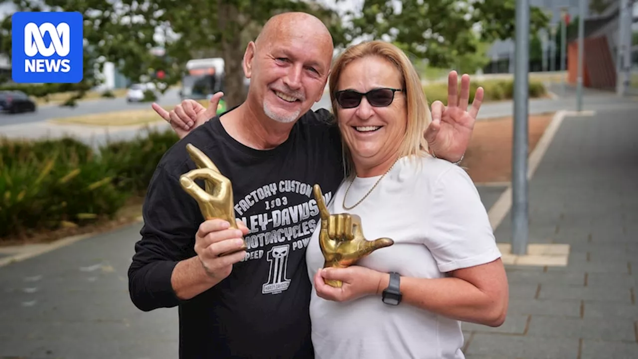 Golden hand statues stolen from grave returned to Canberra family, rose quartz plaque still missing