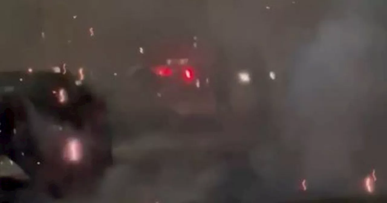 Terrifying footage shows smoke filling street as hooded youths explode fireworks