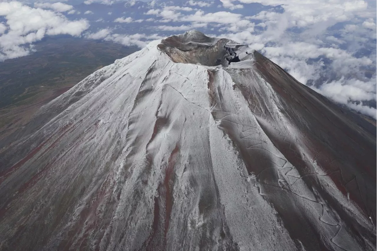 It's not official yet but Mount Fuji gets its trademark snowcap after the longest delay in 130 years