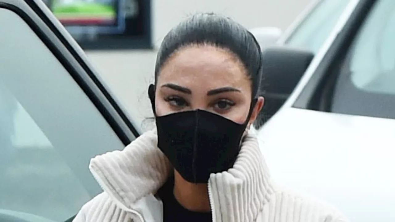 Tulisa hides her face behind surgical mask after revealing the shocking results of swollen TATTOOED...