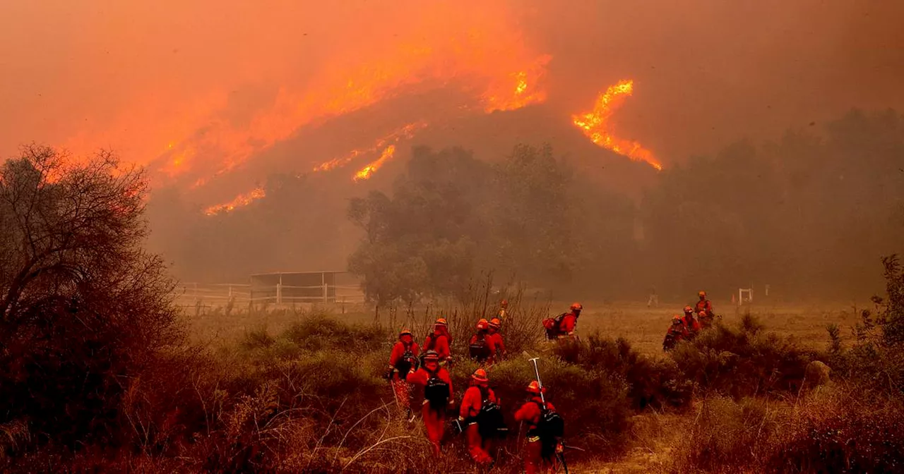 California wildfire burns out of control, but firefighters could get a break when winds diminish