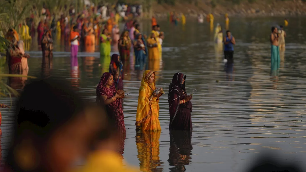 AP PHOTOS: Tens of thousands of Hindu devotees flock to rivers for prayers to the sun god