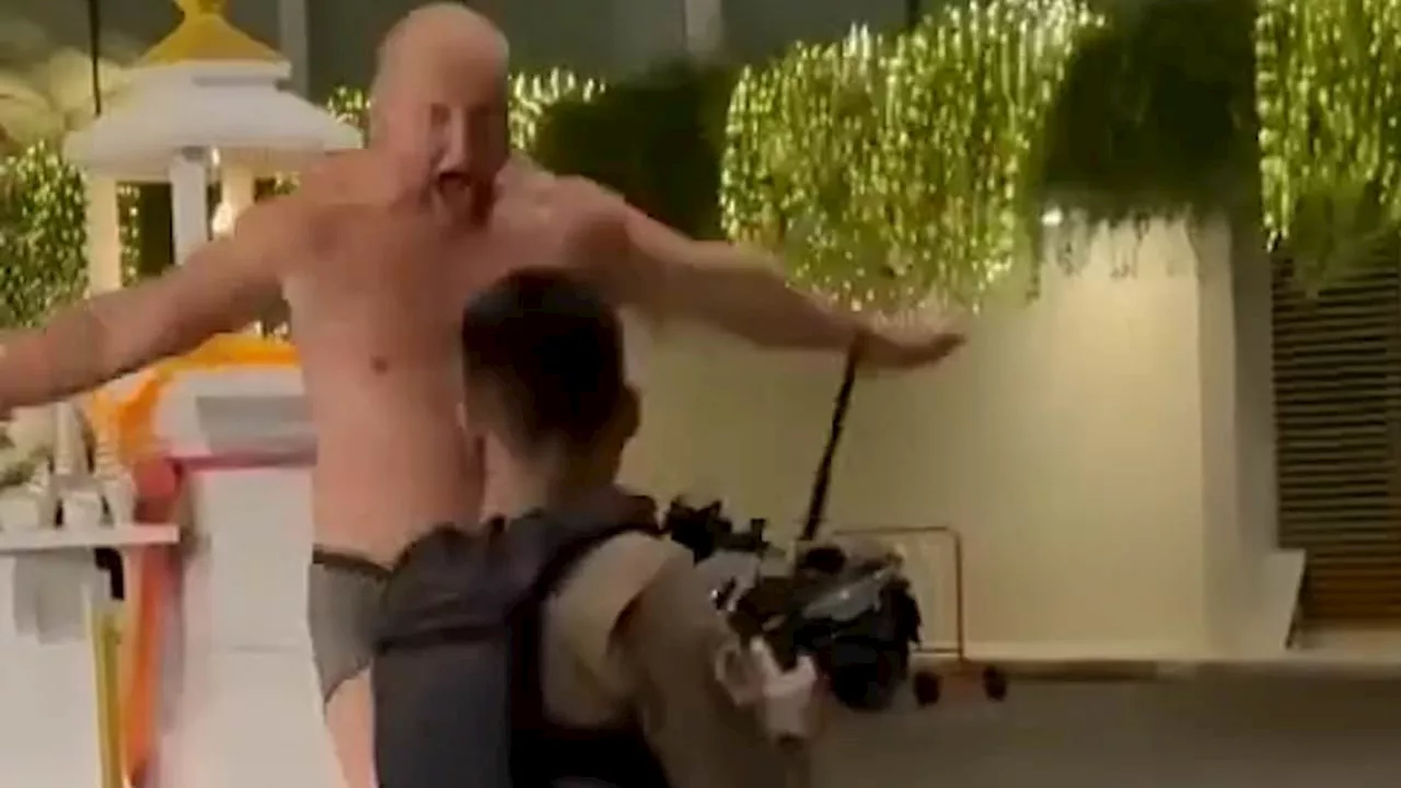 Chaotic moment Russian tourist wearing only underwear tries to fend off seven police officers in...