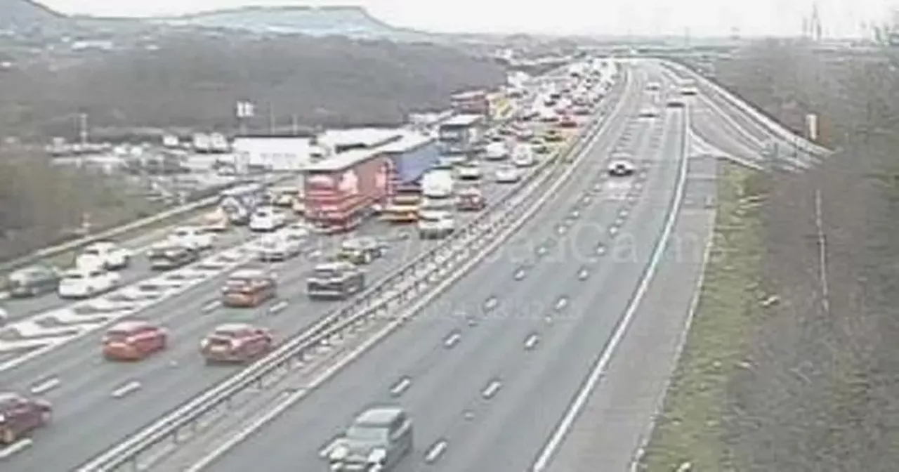 M56 crash LIVE: 90-minute delays with mile-long queues on motorway