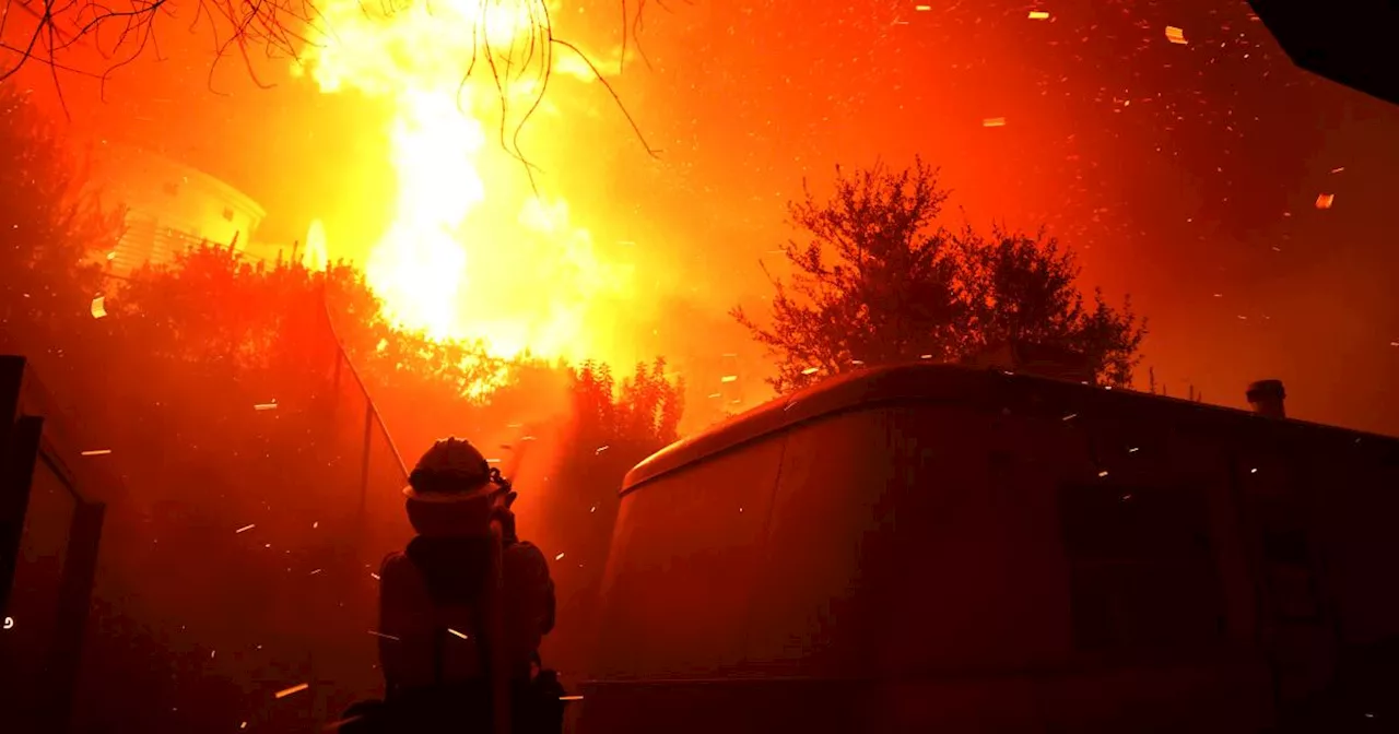 Firefighters struggle to contain wind-driven fire in Malibu threatening homes