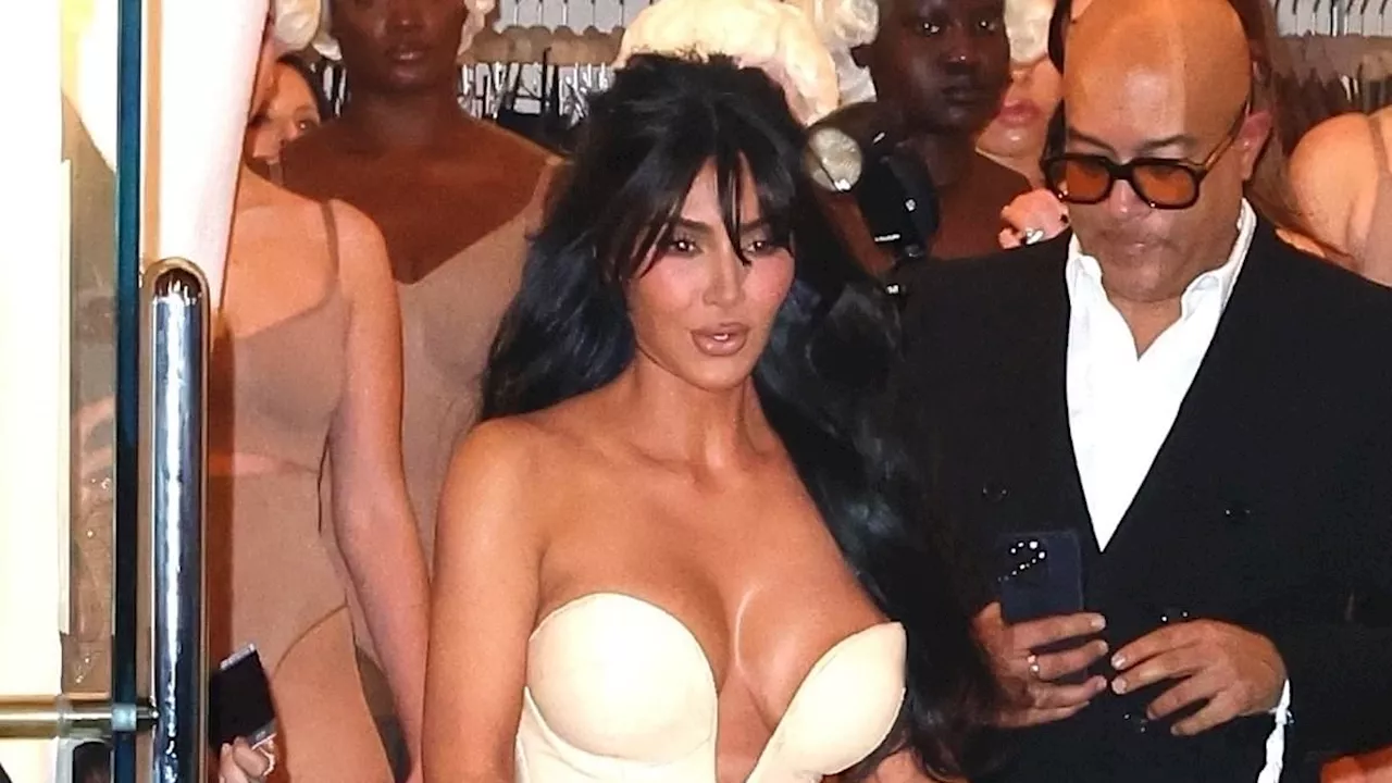 Busty Kim Kardashian wheels herself into SKIMS store with broken foot driving fans wild: 'Still put...