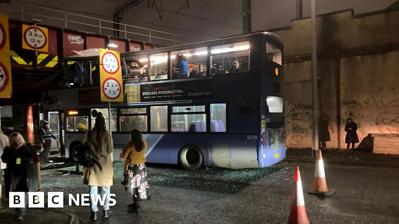 Roof tears off bus after crashing into railway bridge