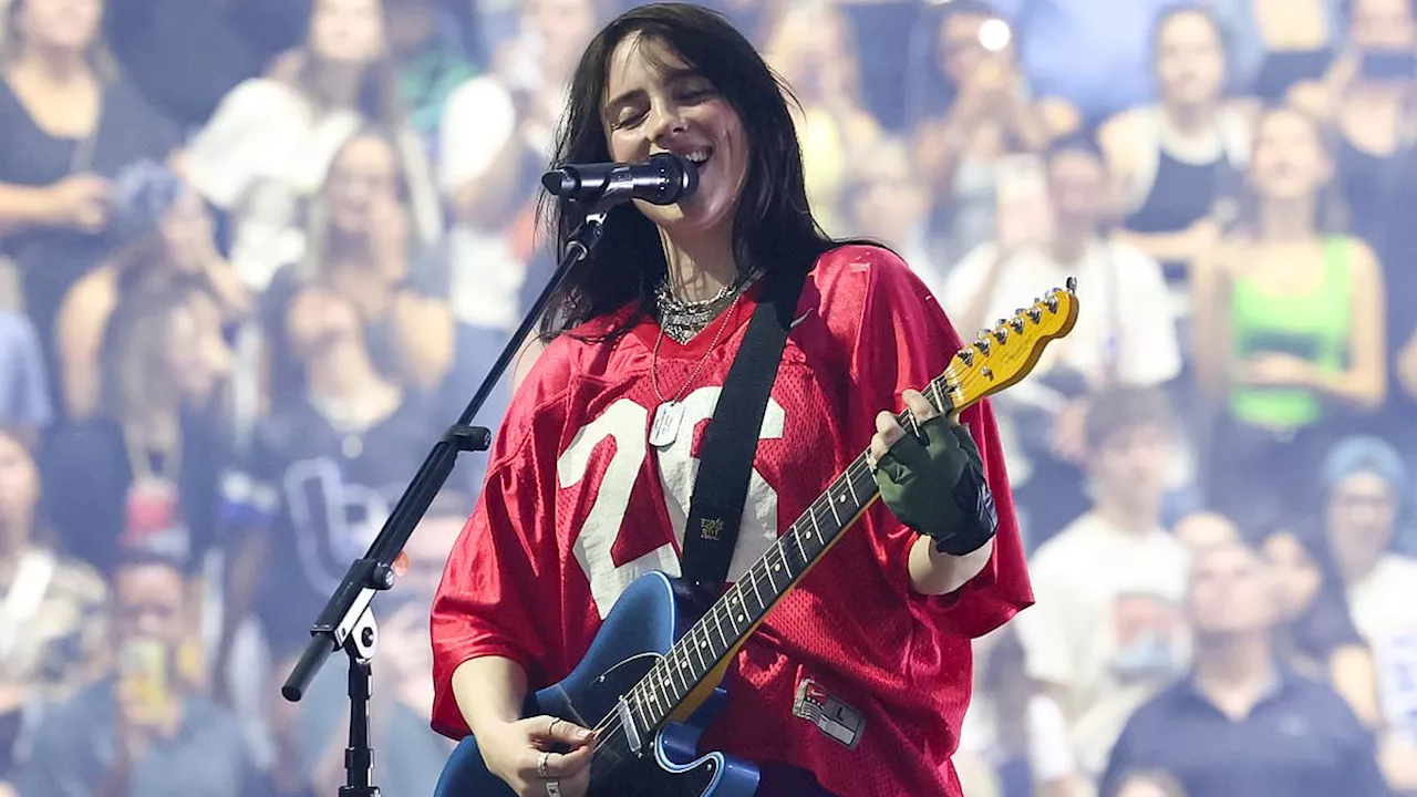 Billie Eilish looks upset after getting struck in the face by a bracelet thrown by a fan at Glendale...