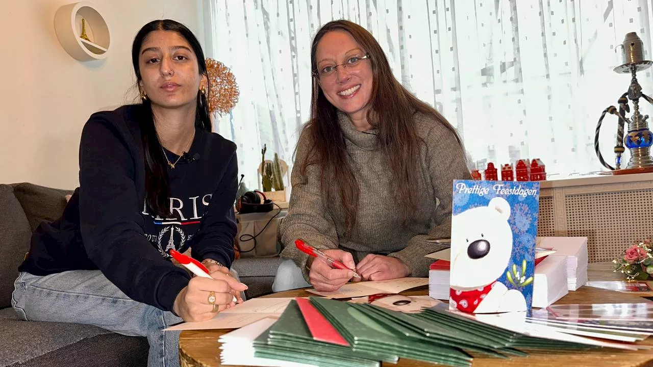 Anita en Alyshia schrijven stapels kerstkaarten voor eenzame ouderen