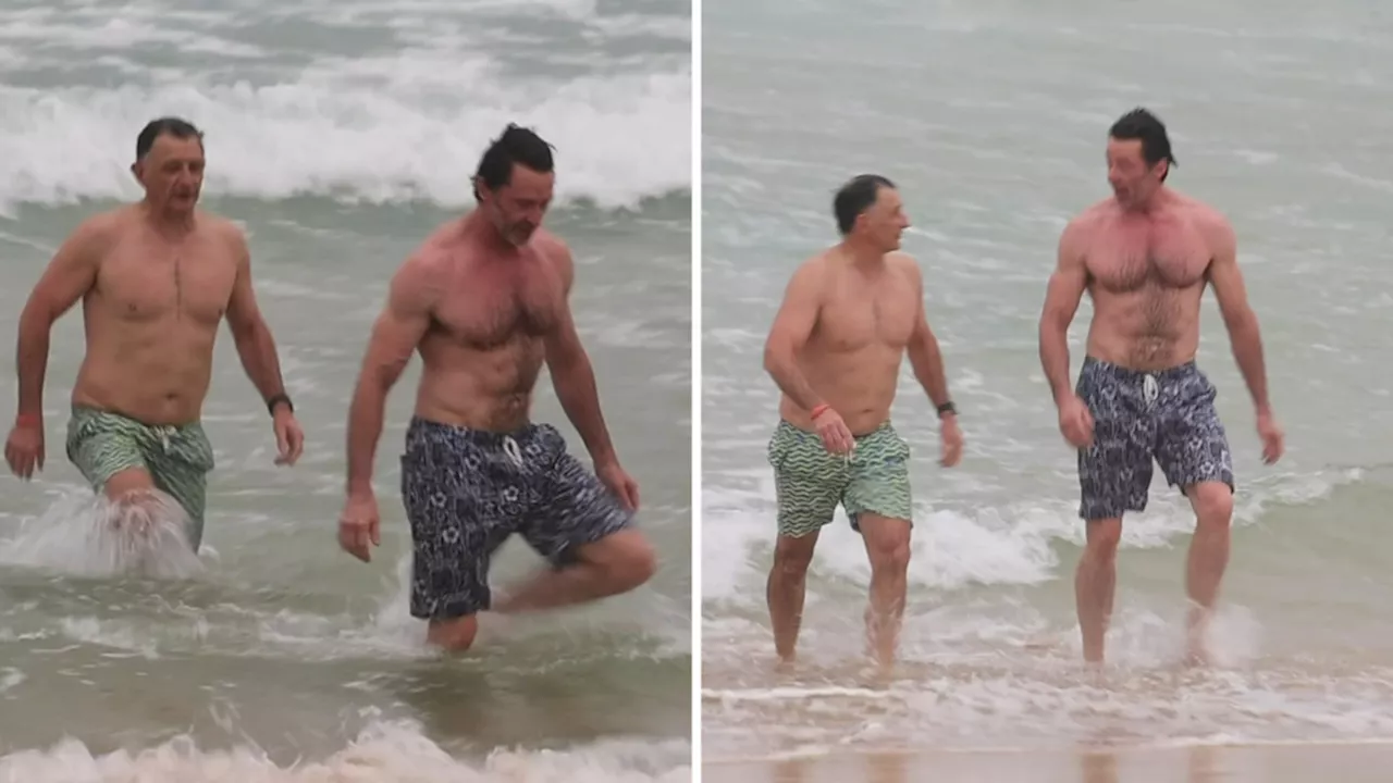 Hugh Jackman shows off ripped physique as he takes a dip at Bondi Beach